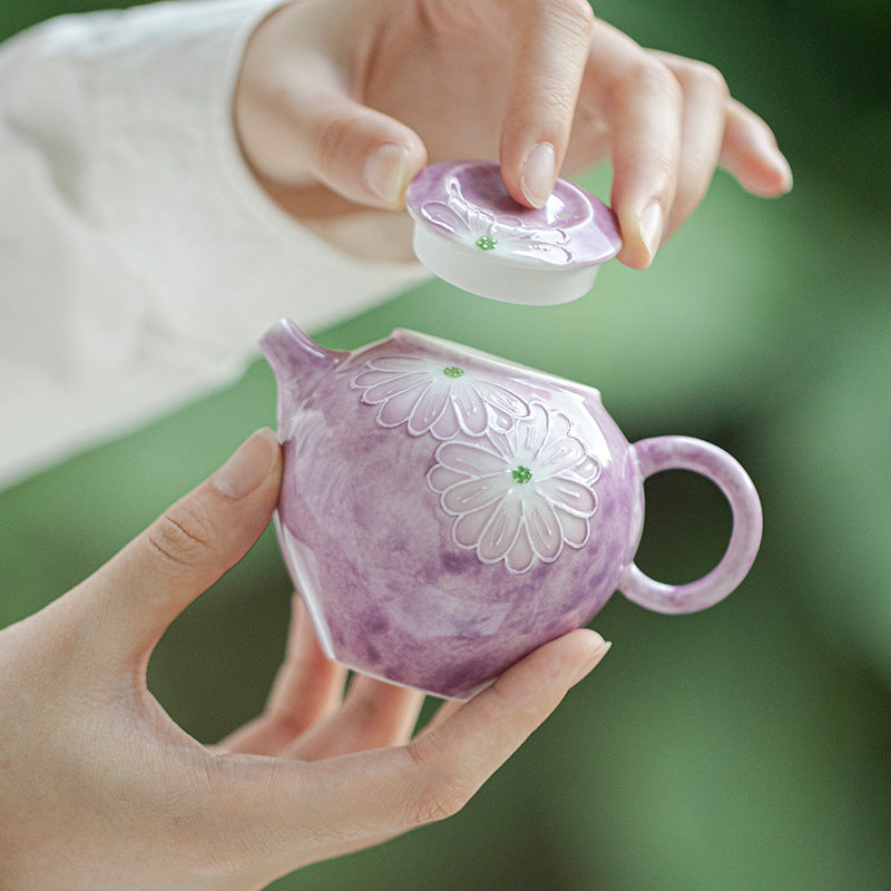 this is a purple ceramic teapot