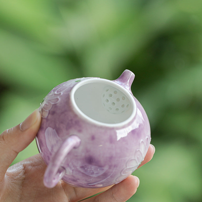 this is a purple ceramic teapot