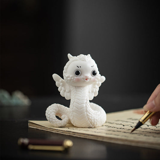 this is a white ceramic snake tea pet