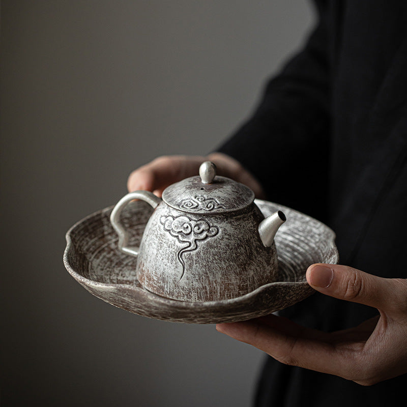 This is a gilted silver pottery teapot