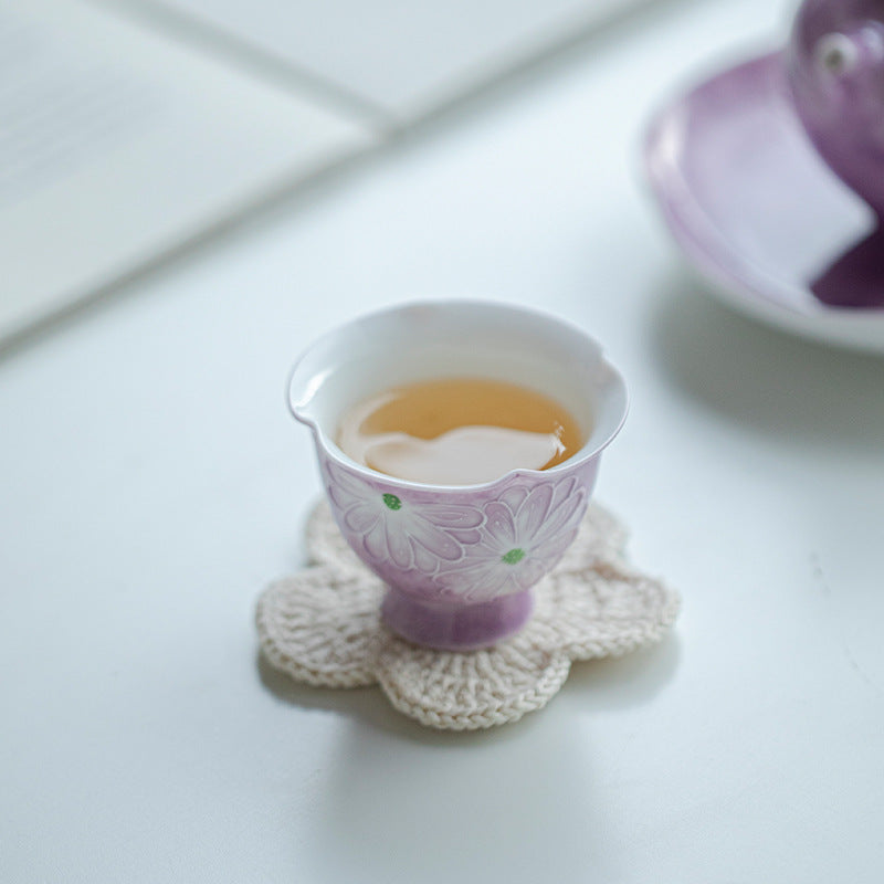 this is a purple ceramic teapot