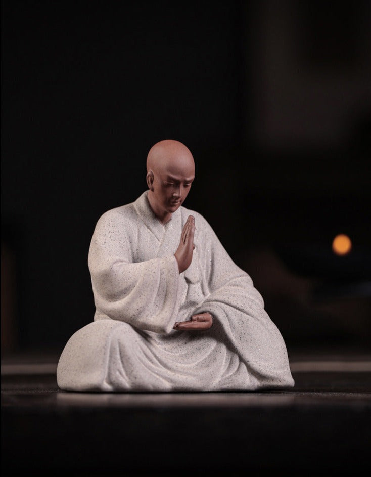 this is a pottery monk sculpture