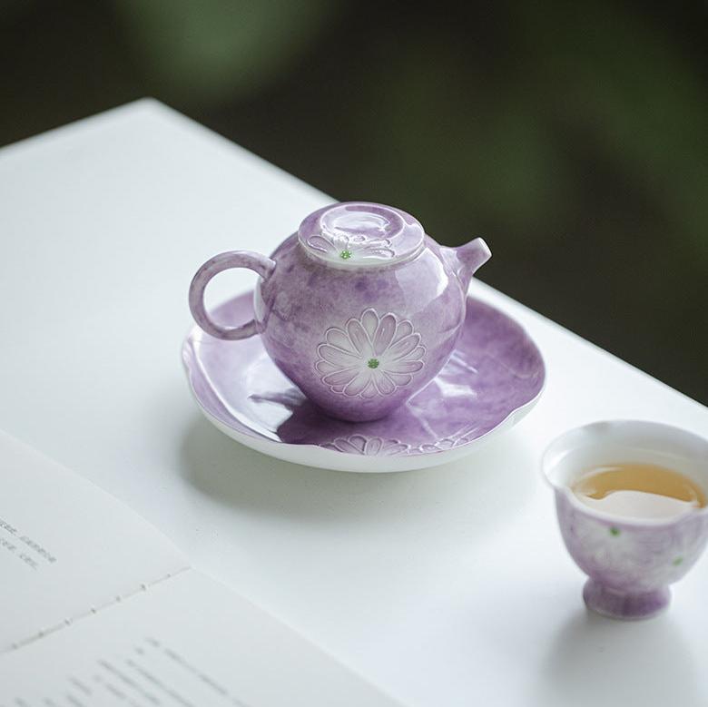 this is a purple ceramic teapot