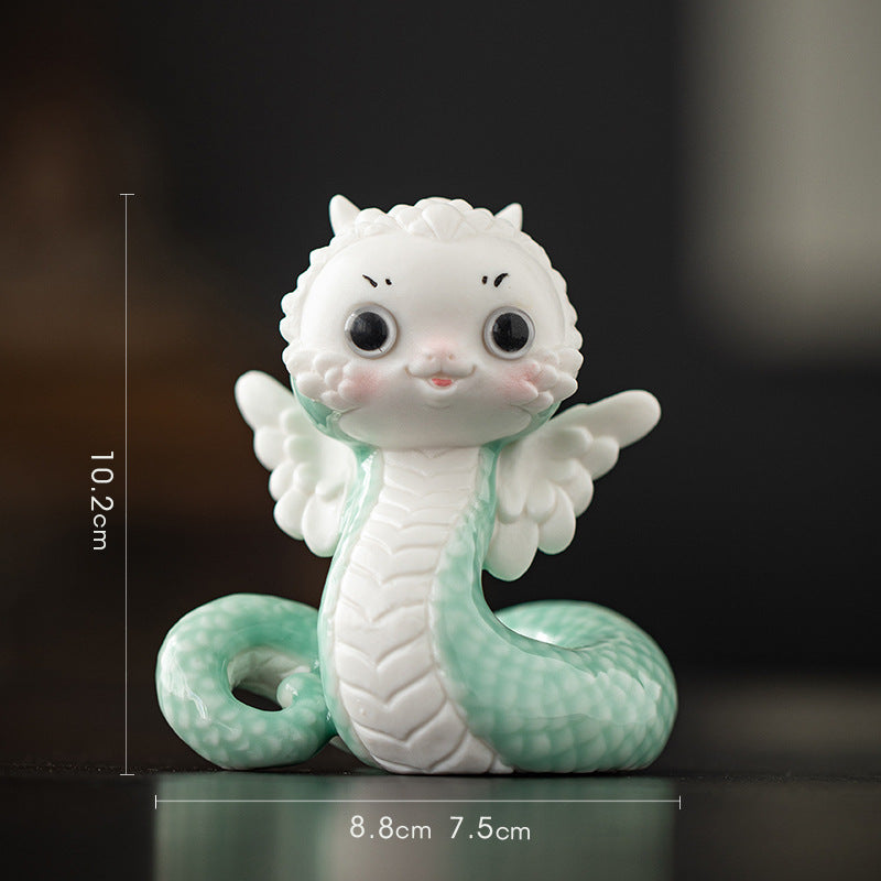 this is a white ceramic snake tea pet