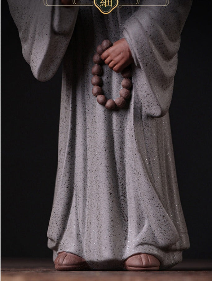 this is a pottery monk sculpture