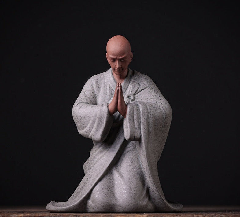 this is a pottery monk sculpture