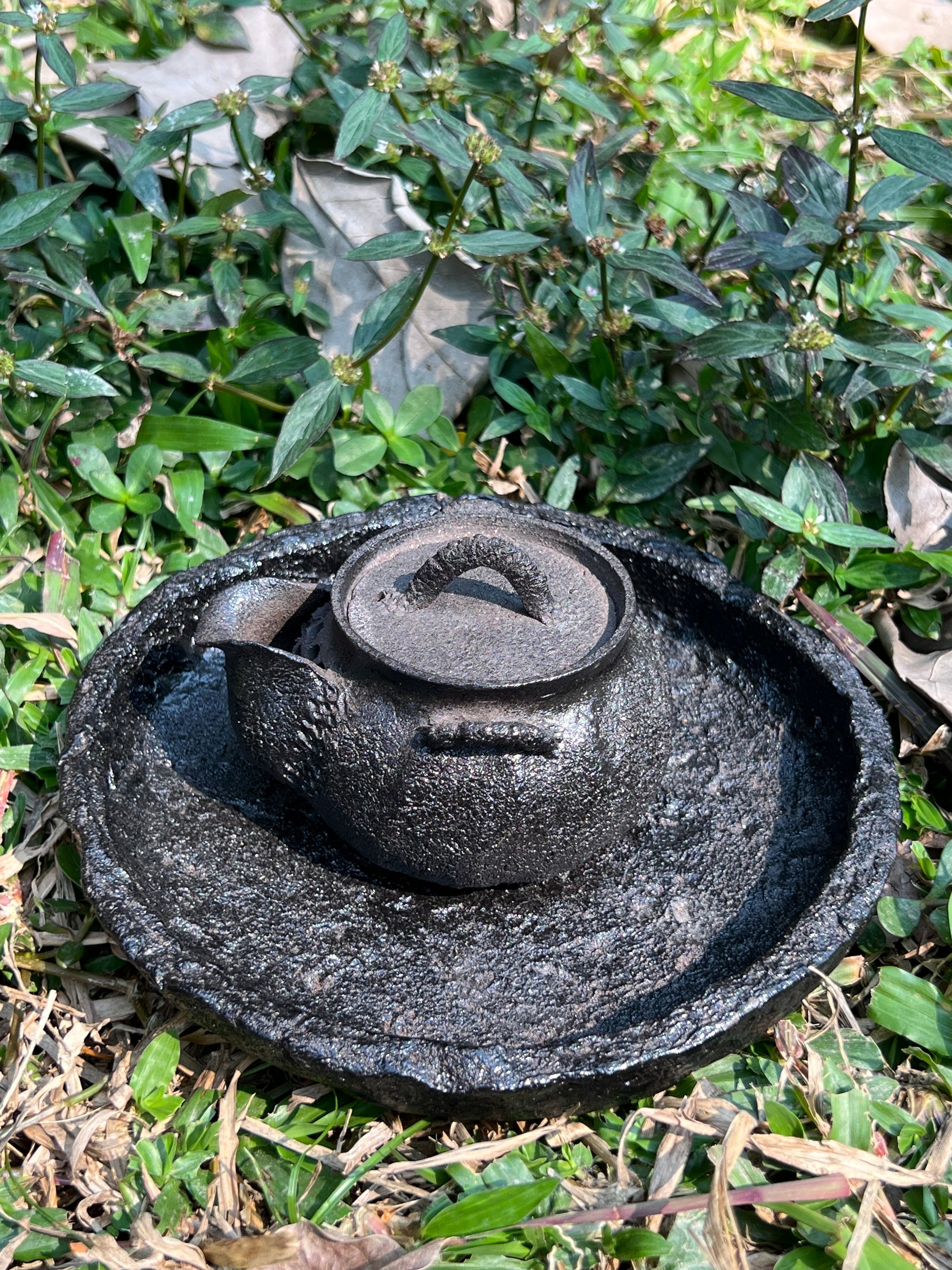 This is a purple clay teapot set