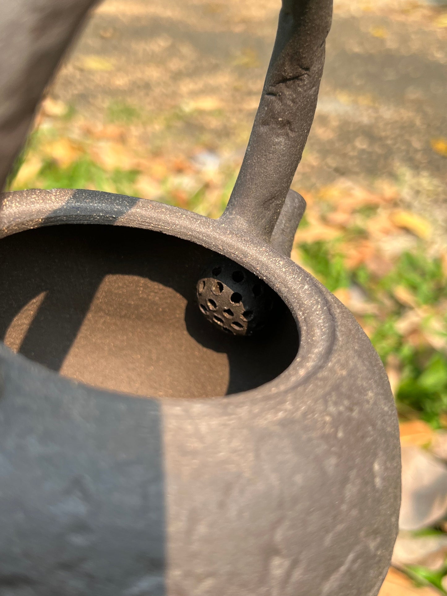 This is a pottery lifting handle kettle