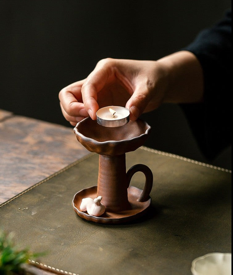 This is a pottery candlestick candle holder