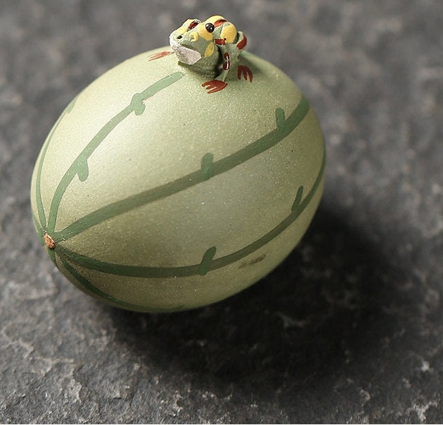 This is a Yixing purple clay water spray frog teapet