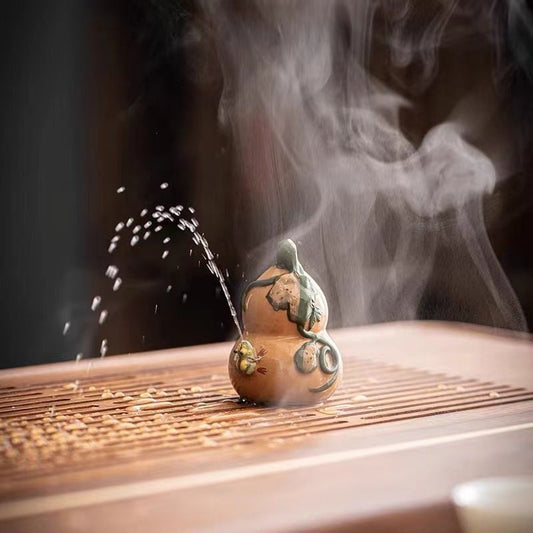 This is a Yixing purple clay water spray frog teapet