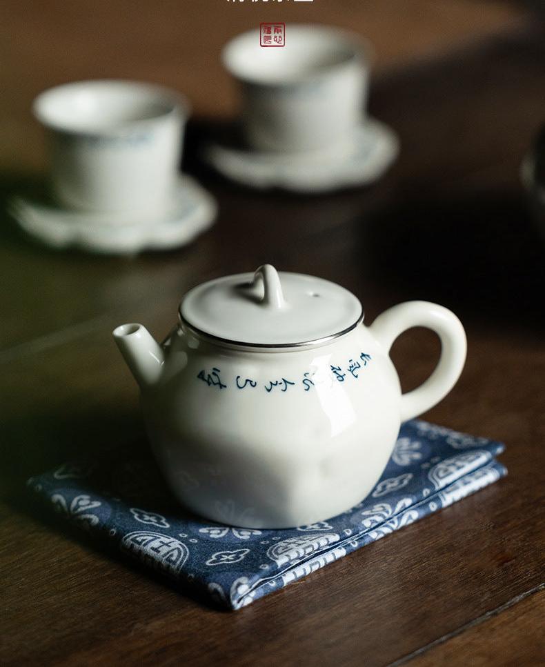 this is a white ceramic teapot