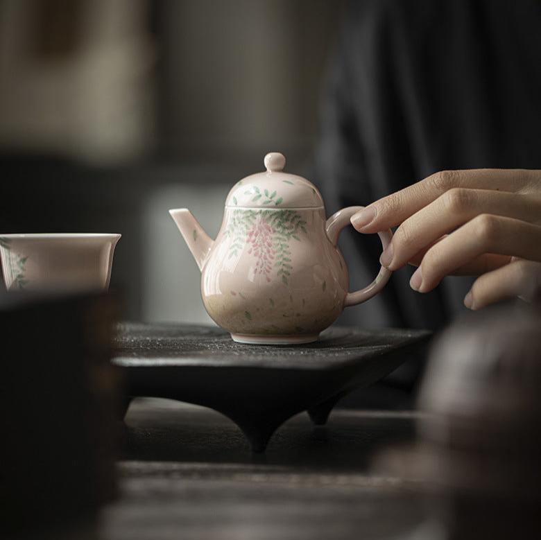 this is a ceramic teapot. this is a pink teapot