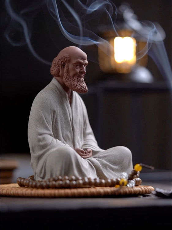 this is a pottery mini bodhidharma sculpture