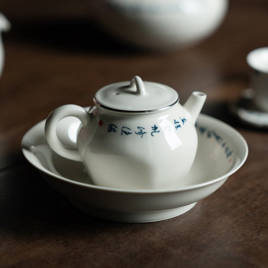 this is a white ceramic teapot