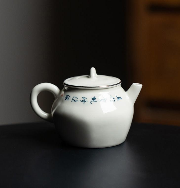 this is a white ceramic teapot