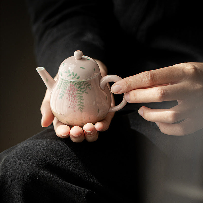 this is a ceramic teapot. this is a pink teapot