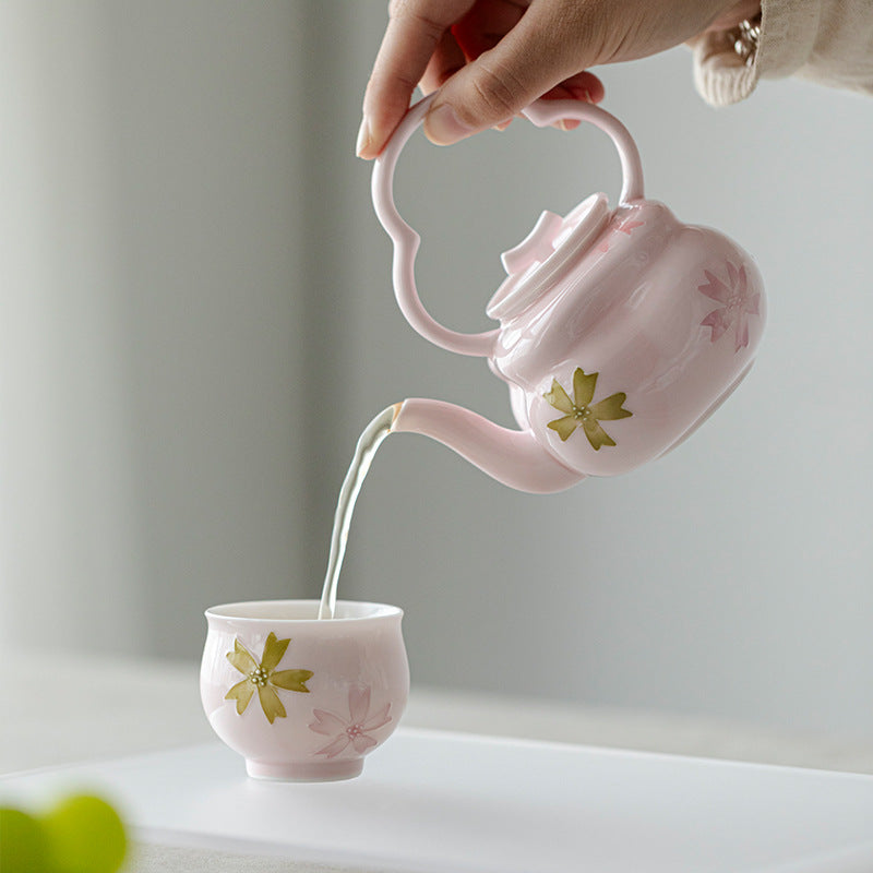 this is a pink ceramic teapot