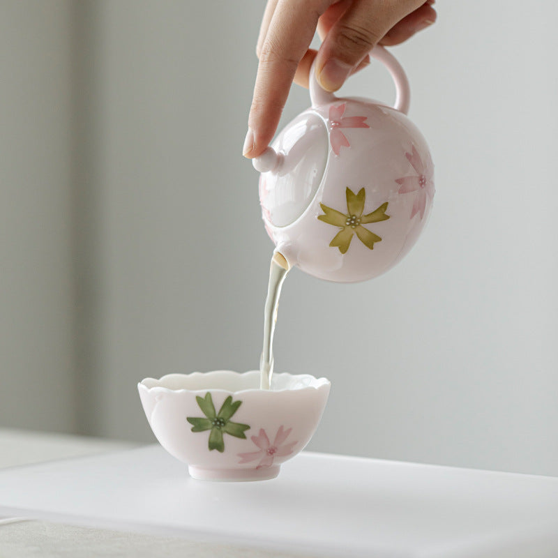 this is a pink ceramic teapot