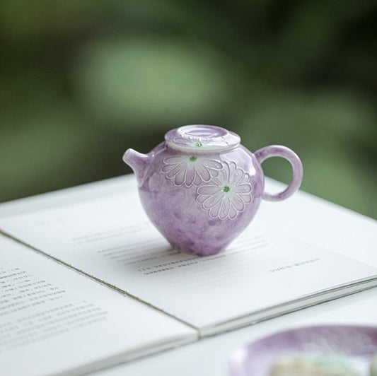 this is a purple ceramic teapot