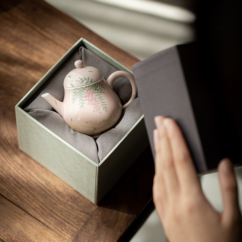 this is a ceramic teapot. this is a pink teapot