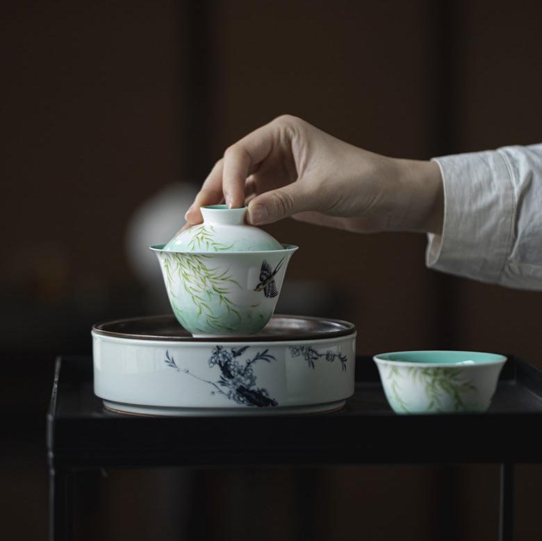 this is a ceramic teapot. this is a green gaiwan