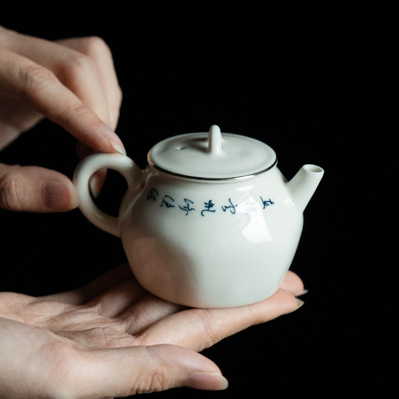 this is a white ceramic teapot