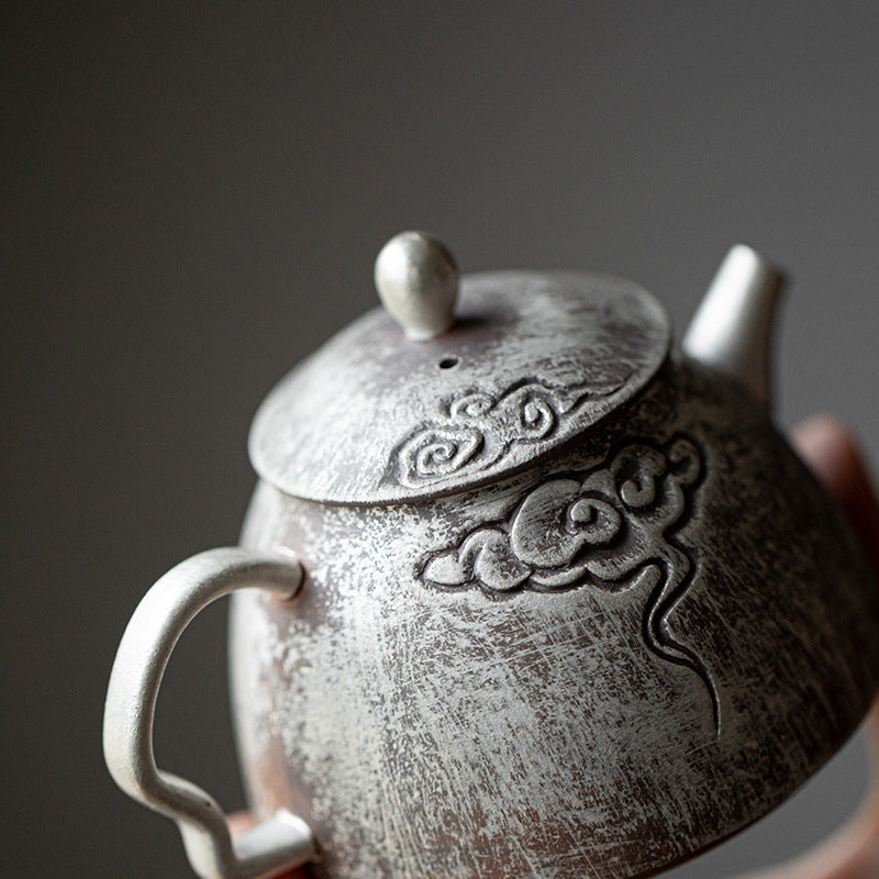 This is a gilted silver pottery teapot 