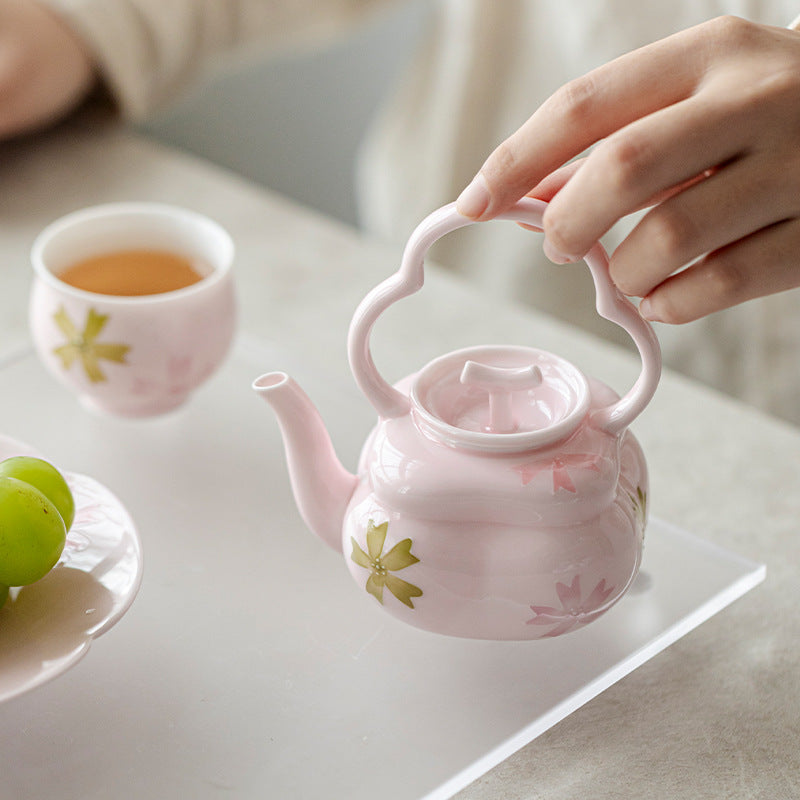 this is a pink ceramic teapot