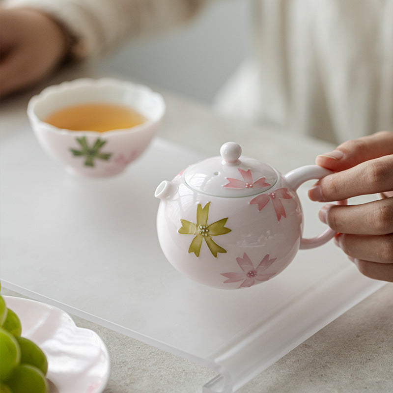 this is a pink ceramic teapot