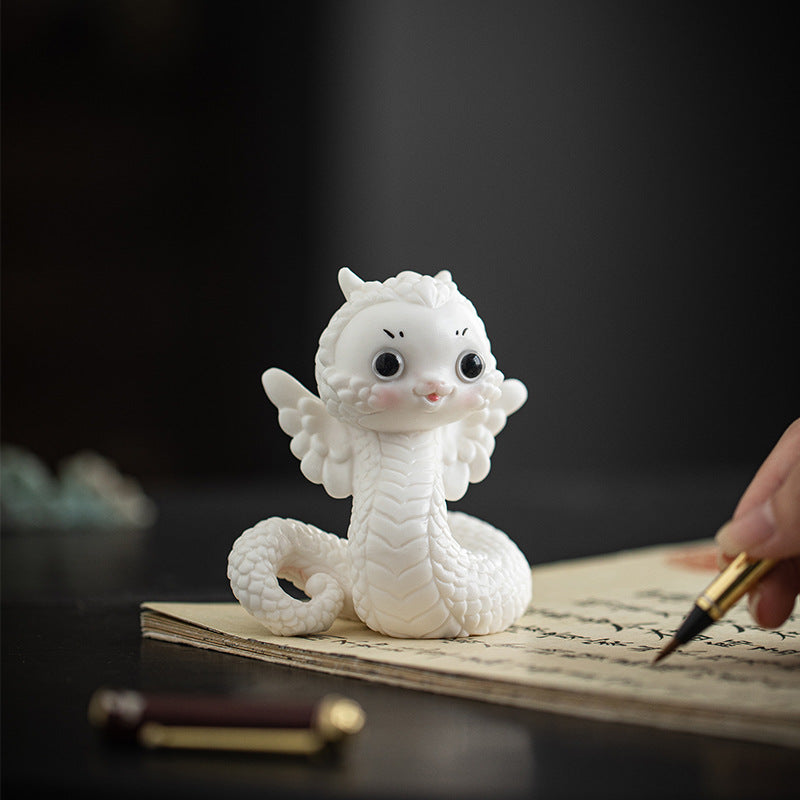 this is a white ceramic snake tea pet