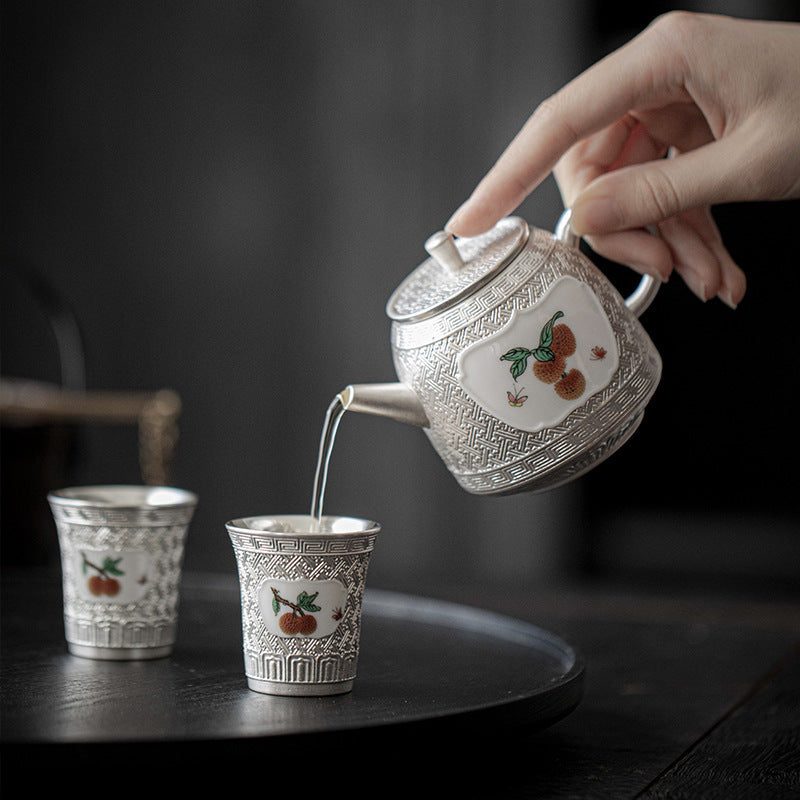 This is a gilted silver ceramic teapot