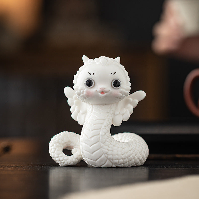 this is a white ceramic snake tea pet
