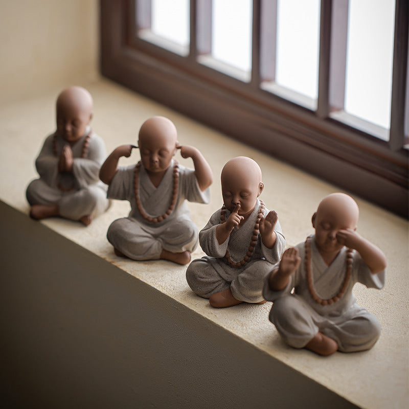 this is a mini pottery monk sculpture