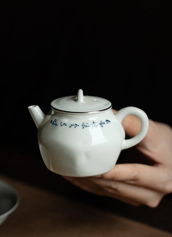 this is a white ceramic teapot