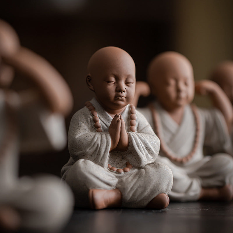 this is a mini pottery monk sculpture