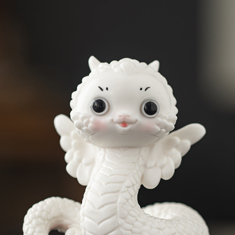 this is a white ceramic snake tea pet