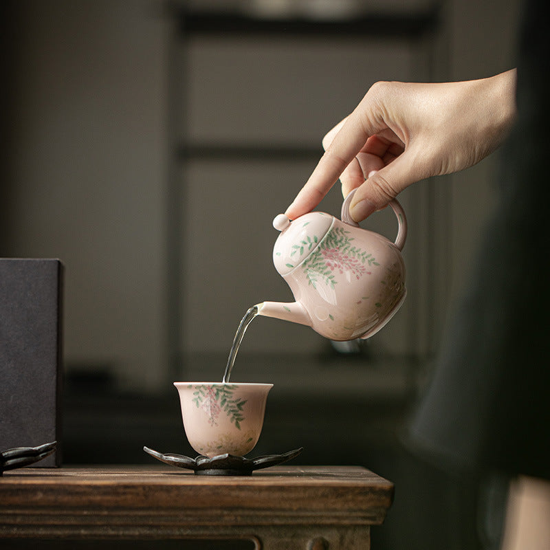 this is a ceramic teapot. this is a pink teapot