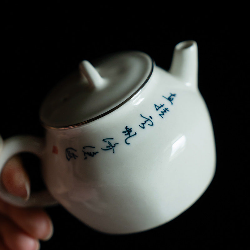 this is a white ceramic teapot