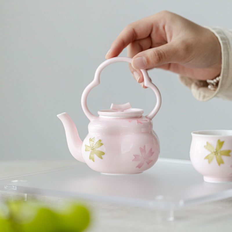 this is a pink ceramic teapot