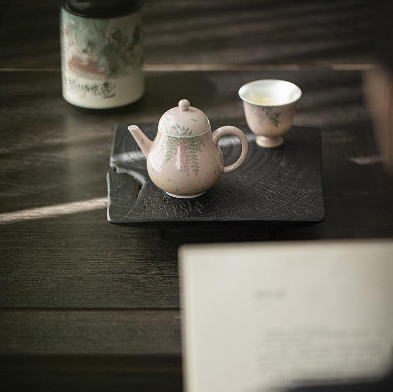 this is a ceramic teapot. this is a pink teapot