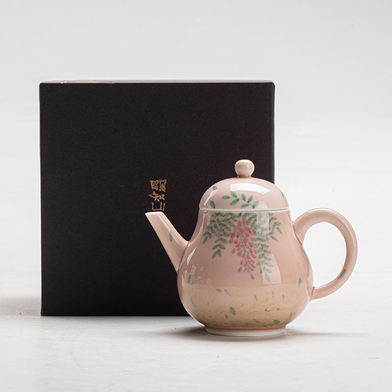 this is a ceramic teapot. this is a pink teapot