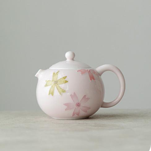 this is a pink ceramic teapot