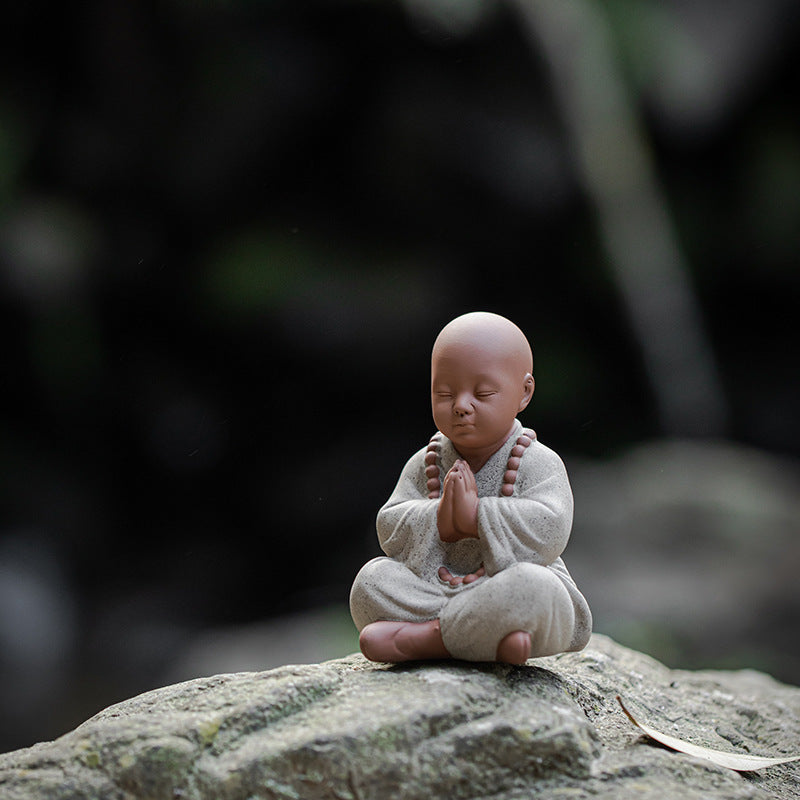 this is a mini pottery monk sculpture