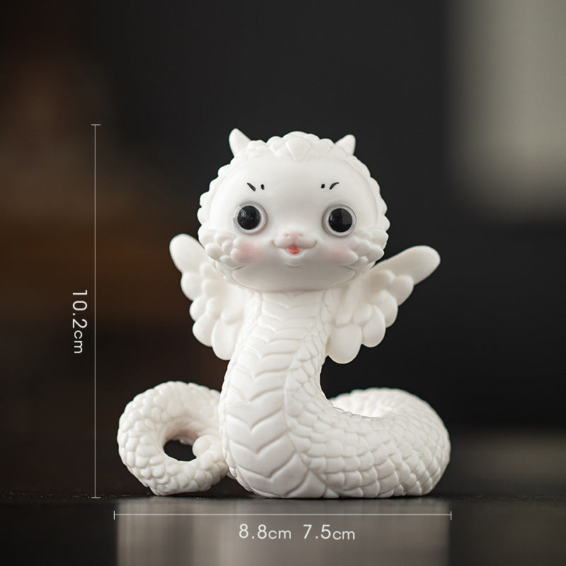 this is a white ceramic snake tea pet