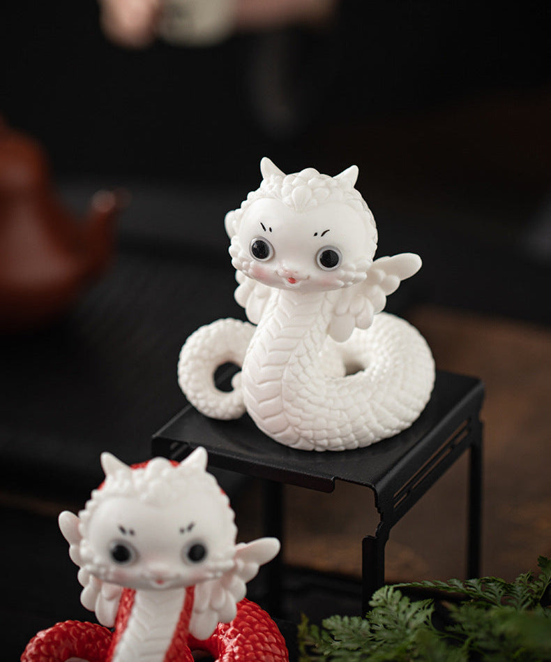 this is a white ceramic snake tea pet