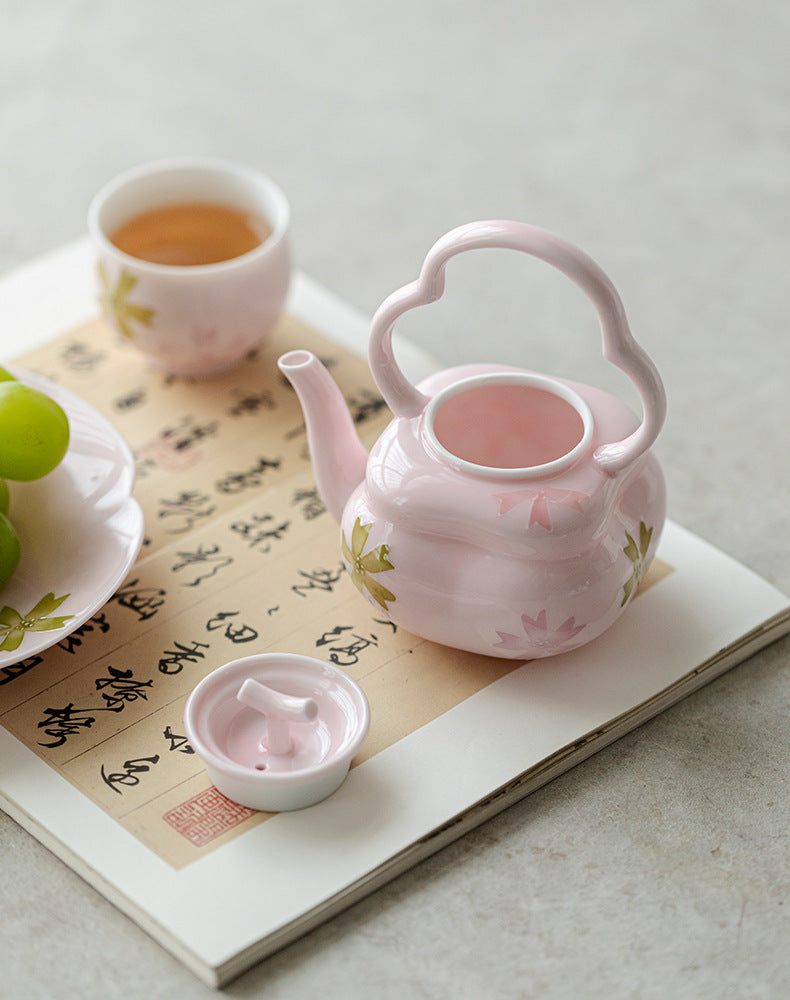 this is a pink ceramic teapot