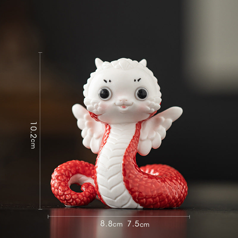 this is a white ceramic snake tea pet