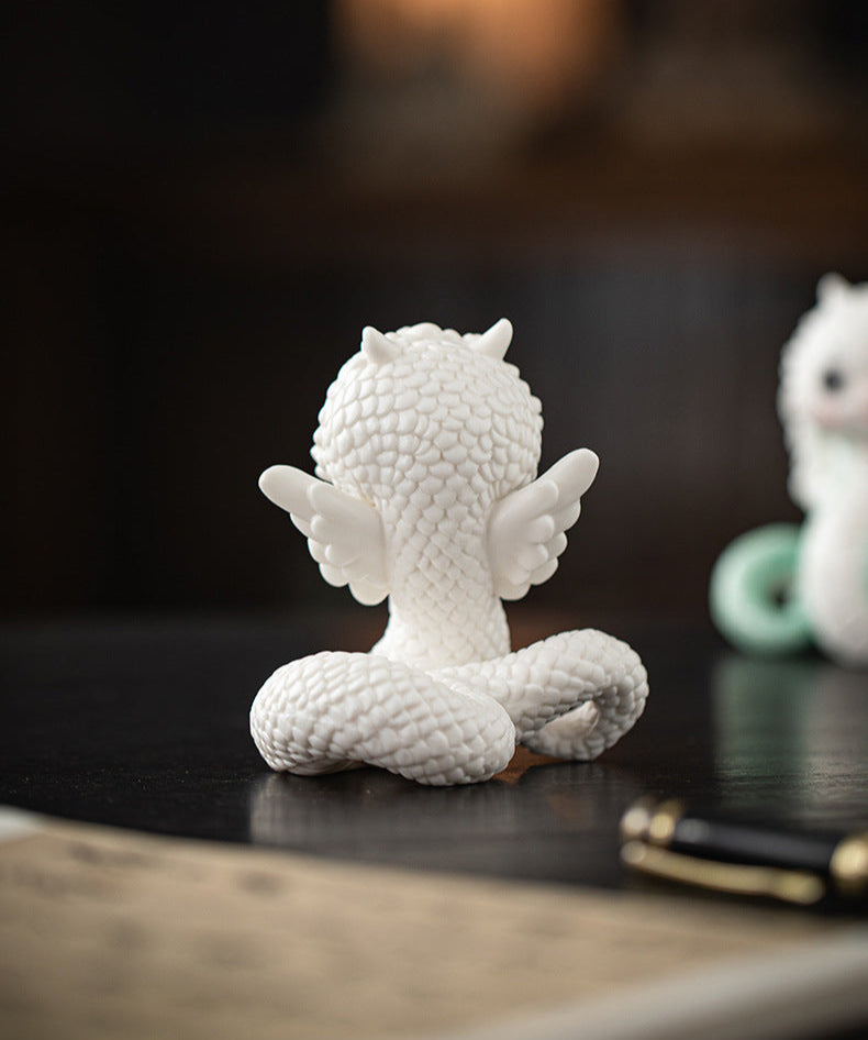 this is a white ceramic snake tea pet