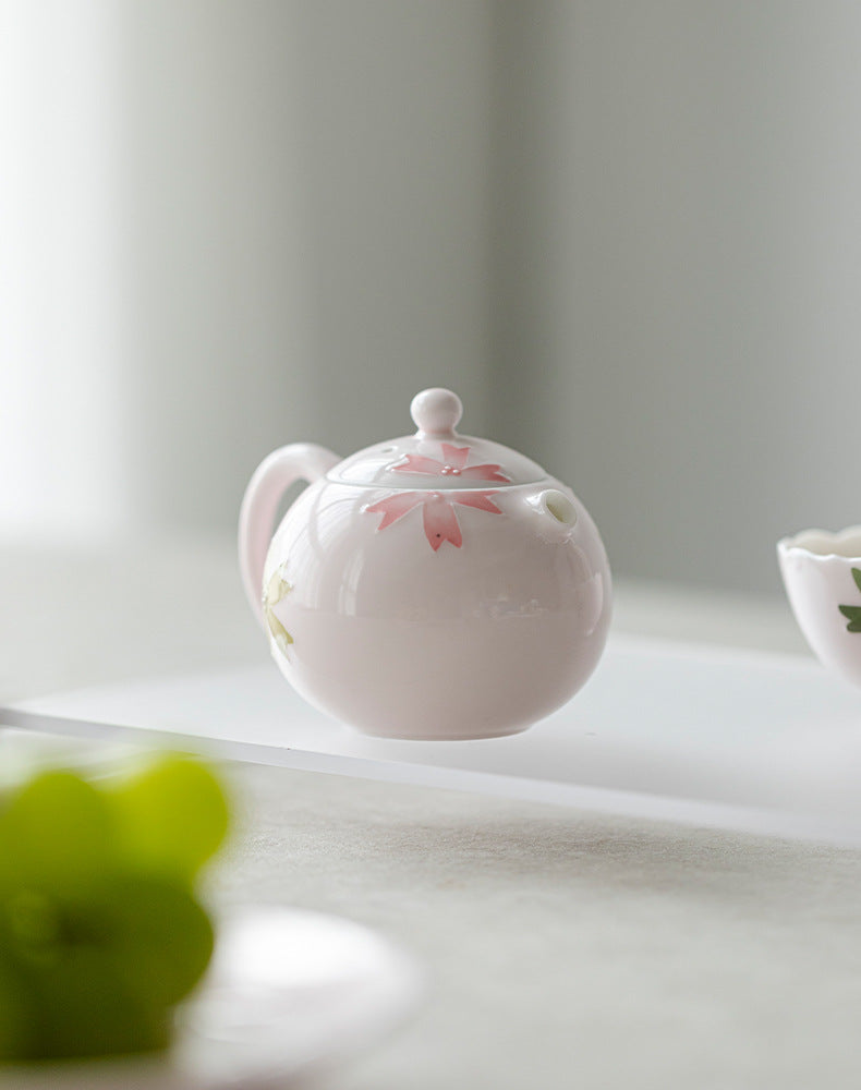 this is a pink ceramic teapot